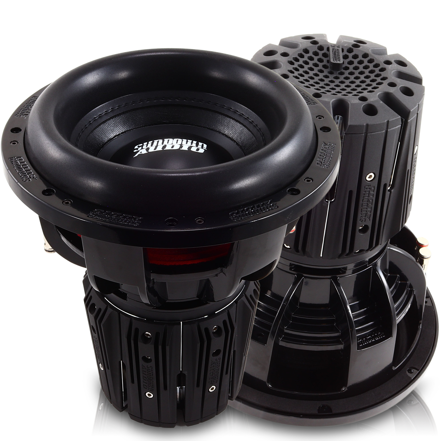 Two large black Nightshade NS-Series NS6 12 3000W Subwoofers from Sundown Audio boast a sleek cylindrical design with ridged sides. The neodymium subs deliver impressive power, adorned with the brand logo on the glossy top, while advanced thermal management ensures optimal performance.