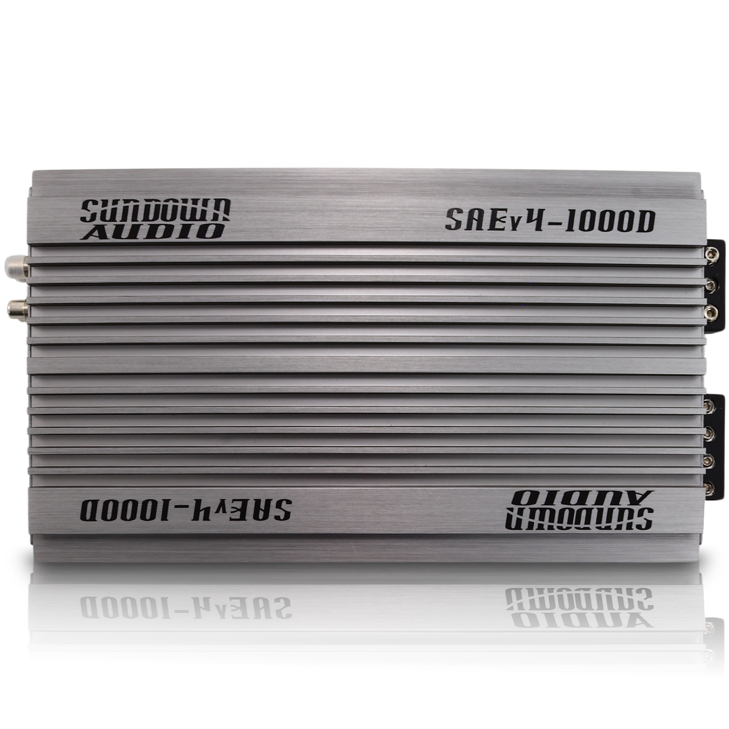 Three Sundown Audio SAEv4-1000.1D amplifiers stacked, featuring a sleek metallic silver finish with black logos. These Class D mono amplifiers boast modern design elements, visible screws, and connection ports on one edge for easy installation.