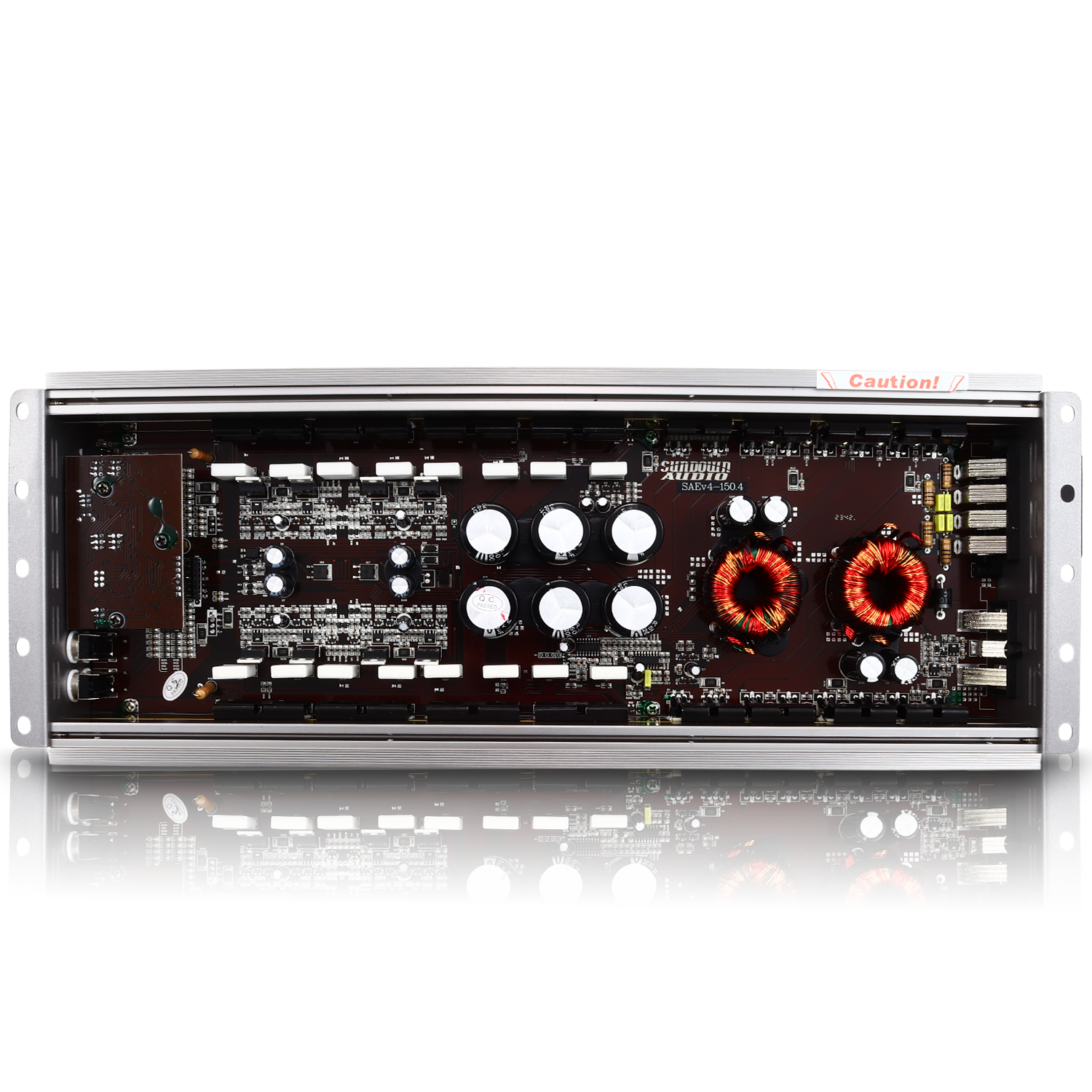 The Sundown Audio SAEv4-150.4 4-Channel Amplifier features a high-fidelity Class A/B architecture on its circuit board with capacitors, resistors, and coils mounted in an open metal enclosure, reflecting on a shiny surface below.
