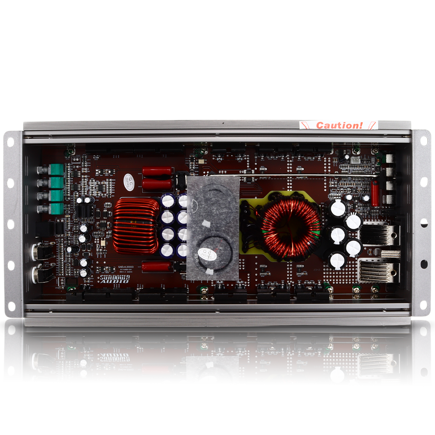 Interior view of the Sundown Audio SAEv4-2000.1D Amplifier circuit board with capacitors, coils, and other thermal control components inside a metallic frame. A red label at the top says Caution! The board reflects below.
