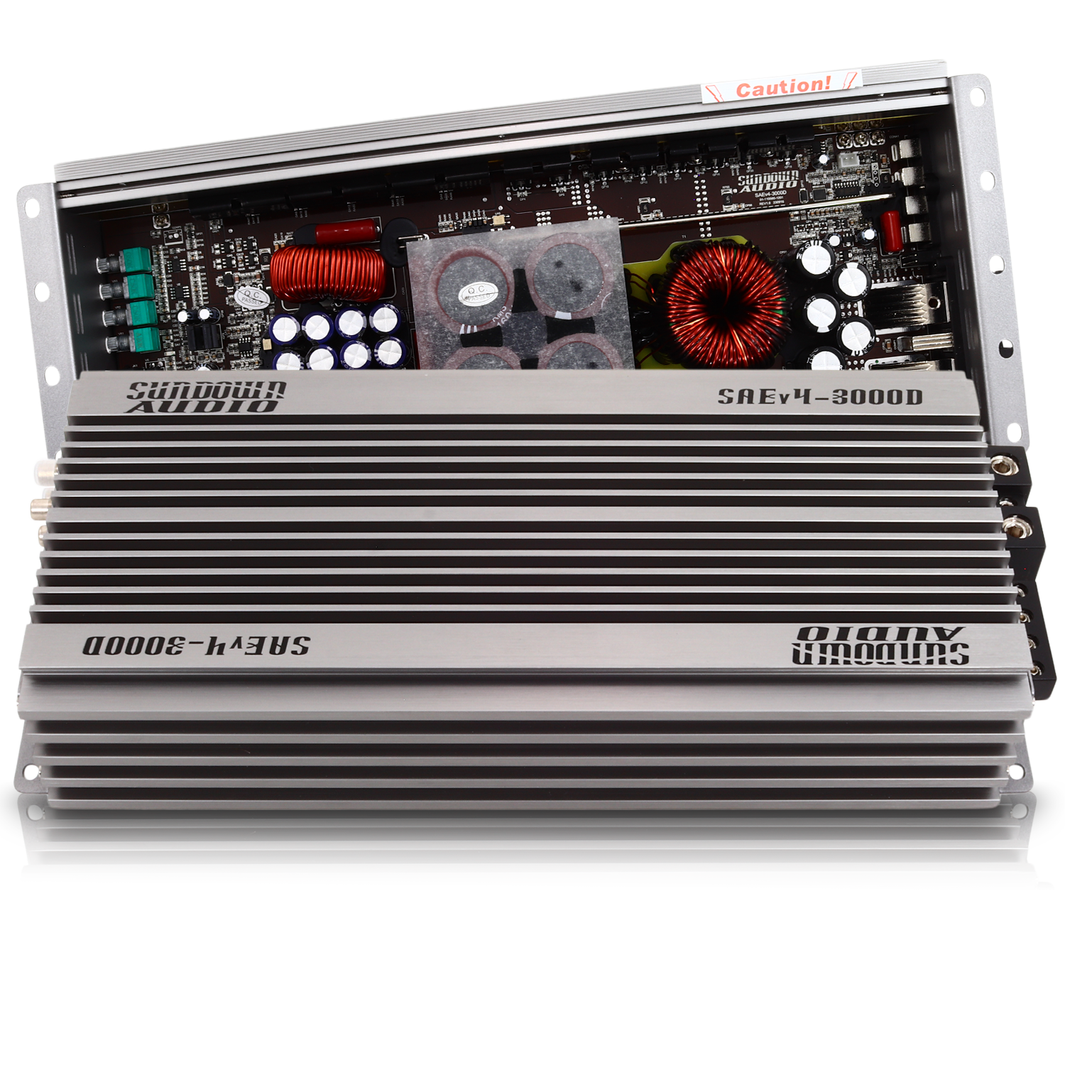 The Sundown Audio SAEv4-3000.1D amplifier is a sleek silver Class D car audio amp with visible internal components like coils and capacitors. Its ribbed casing and protective circuitry ensure top performance, while the partially open top reveals the circuit board inside.