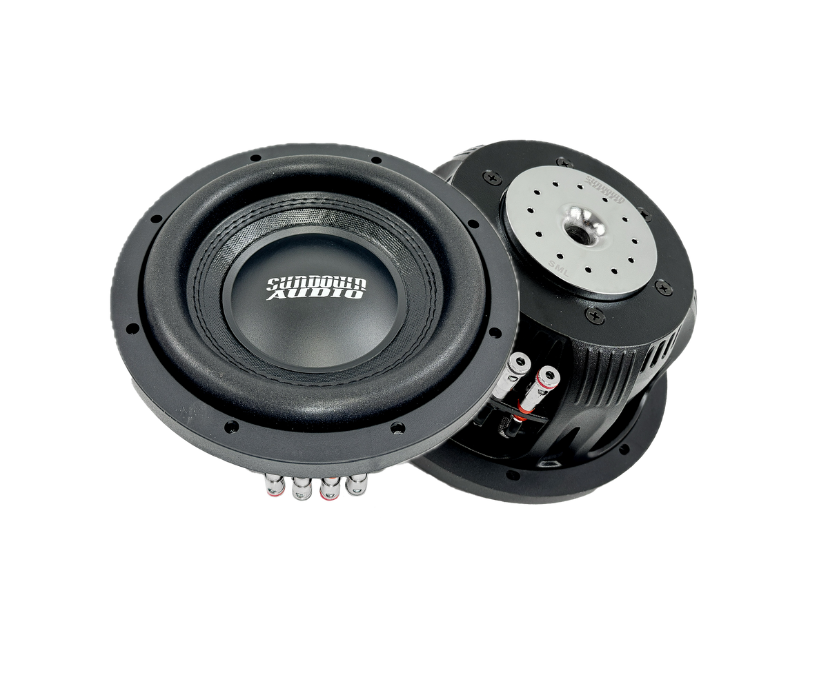 Two black Sundown Audio SML-Series 8” Thin Subwoofers are set against a white background; one shows the Sundown Audio label face up, while the other displays the back with its metallic magnet and connection points, emphasizing their exceptional design and quality.