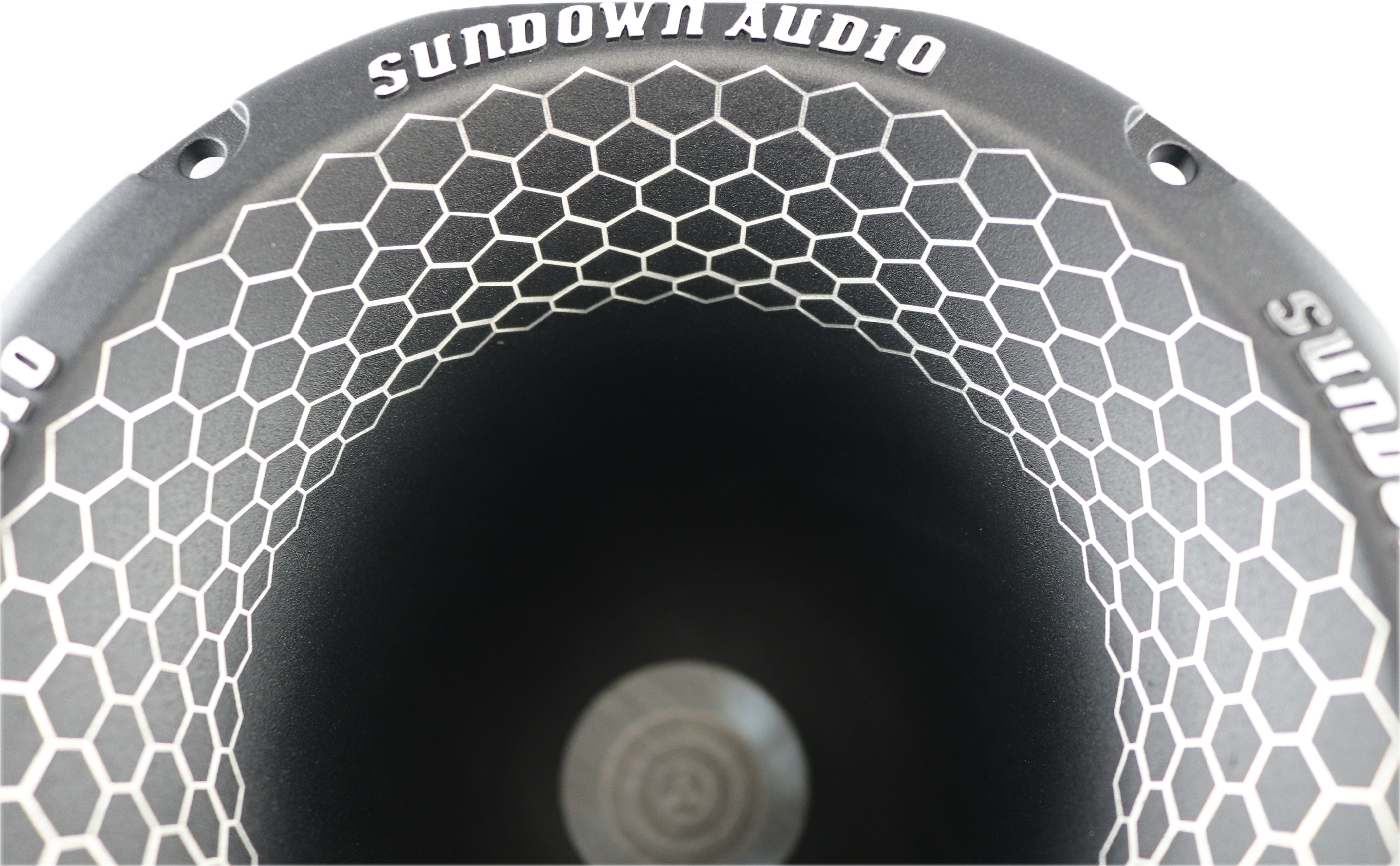 The SHNMD 2 Throat NEO Super Horn by Sundown Audio features a speaker cone with hexagonal patterns of die-cast aluminum on the interior, while Sundown Audio is printed on the edge, all set against a black background that highlights its precision engineering.