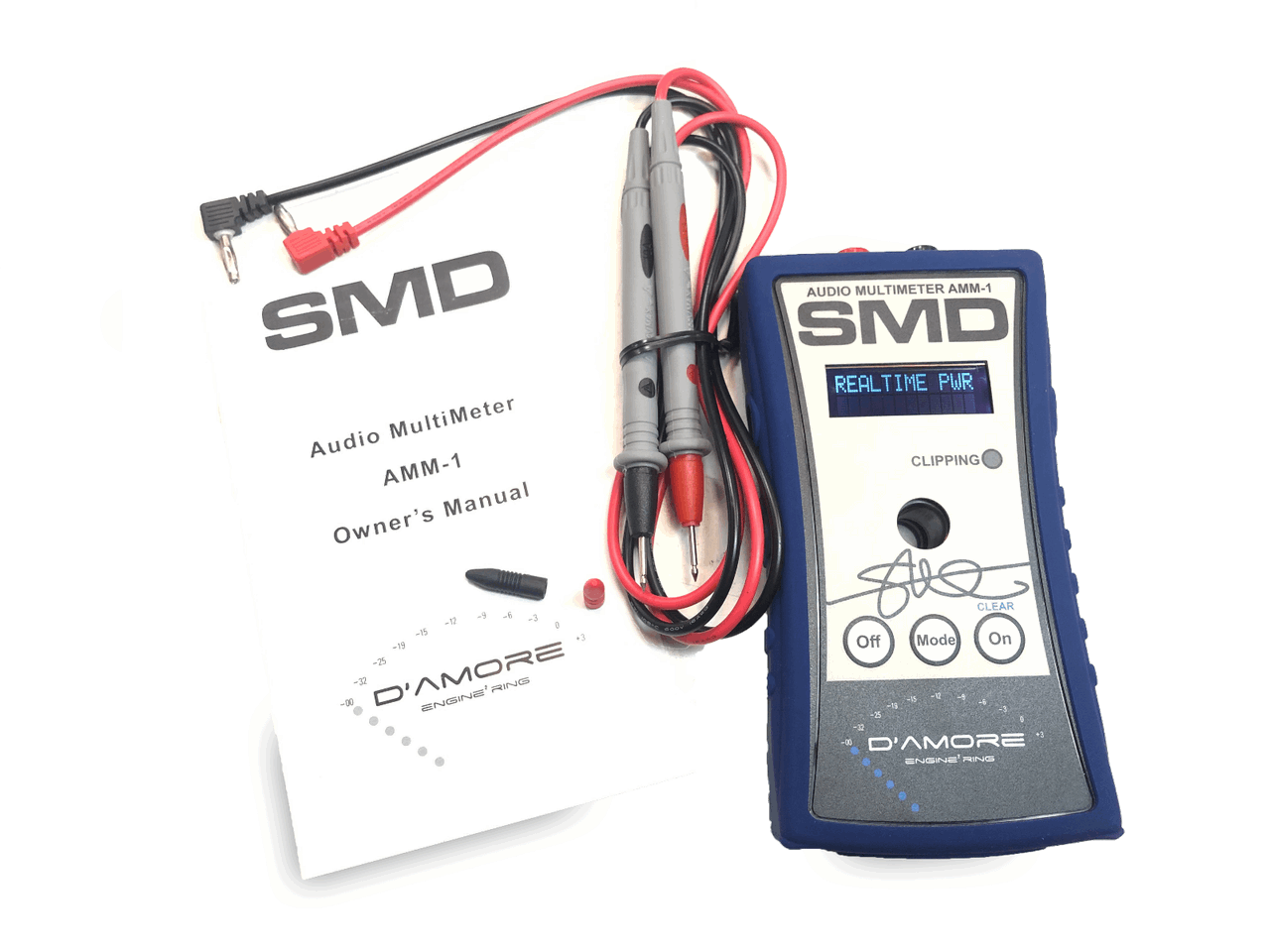 Image of the SMD Audio Multimeter AMM-1 by Steve Meade Designs, highlighting subwoofer tuning features with measurement leads connected. It's positioned next to a black user manual featuring the SMD logo and text.