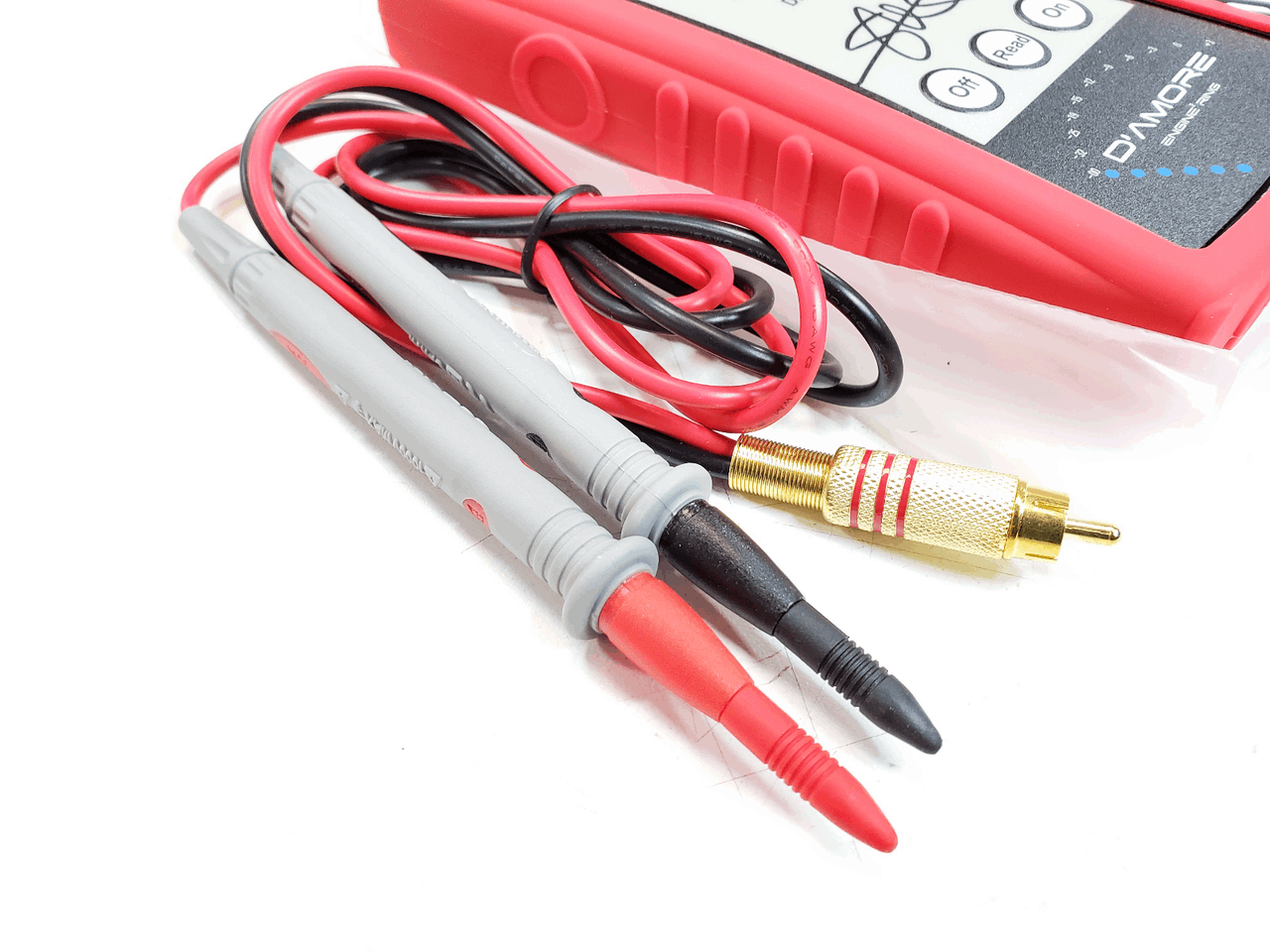 A close-up image of the SMD Distortion Detector Plus (DD-1+) Digital Microcontroller from Steve Meade Designs, featuring red and black test probes perfect for gain setting. The device comes with a red protective cover, and the probes are connected by wires with metal tips. An RCA connector is also included, enhancing its usefulness in audio amplifier setups.