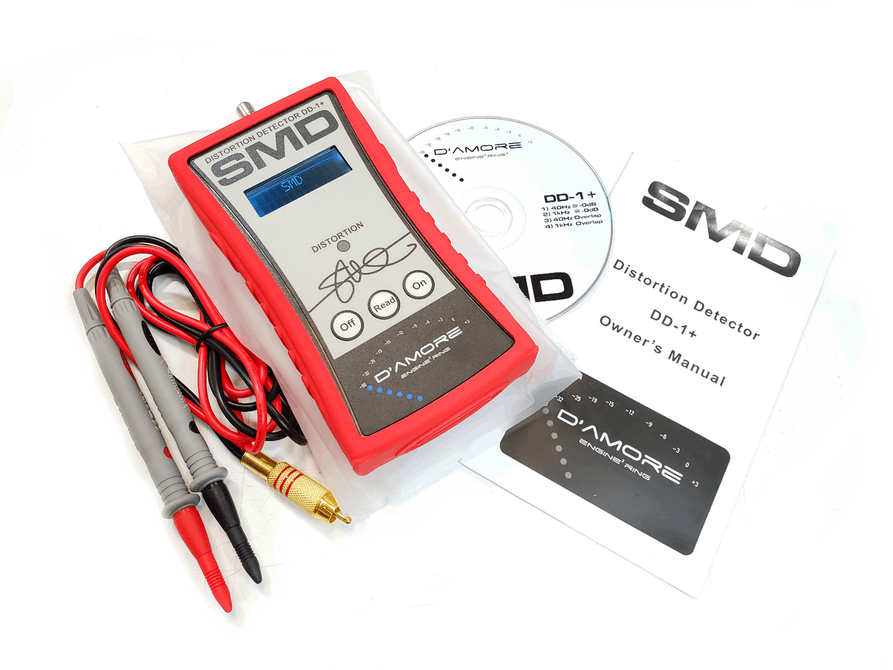 The SMD Distortion Detector Plus (DD-1+) by Steve Meade Designs is a red and white digital microcontroller distortion detection tool featuring probes, a CD labeled DD-1+, a business card, and an SMD logo sticker. It includes a digital display for precise numerical readings, making it perfect for setting gain in audio amplifier projects.