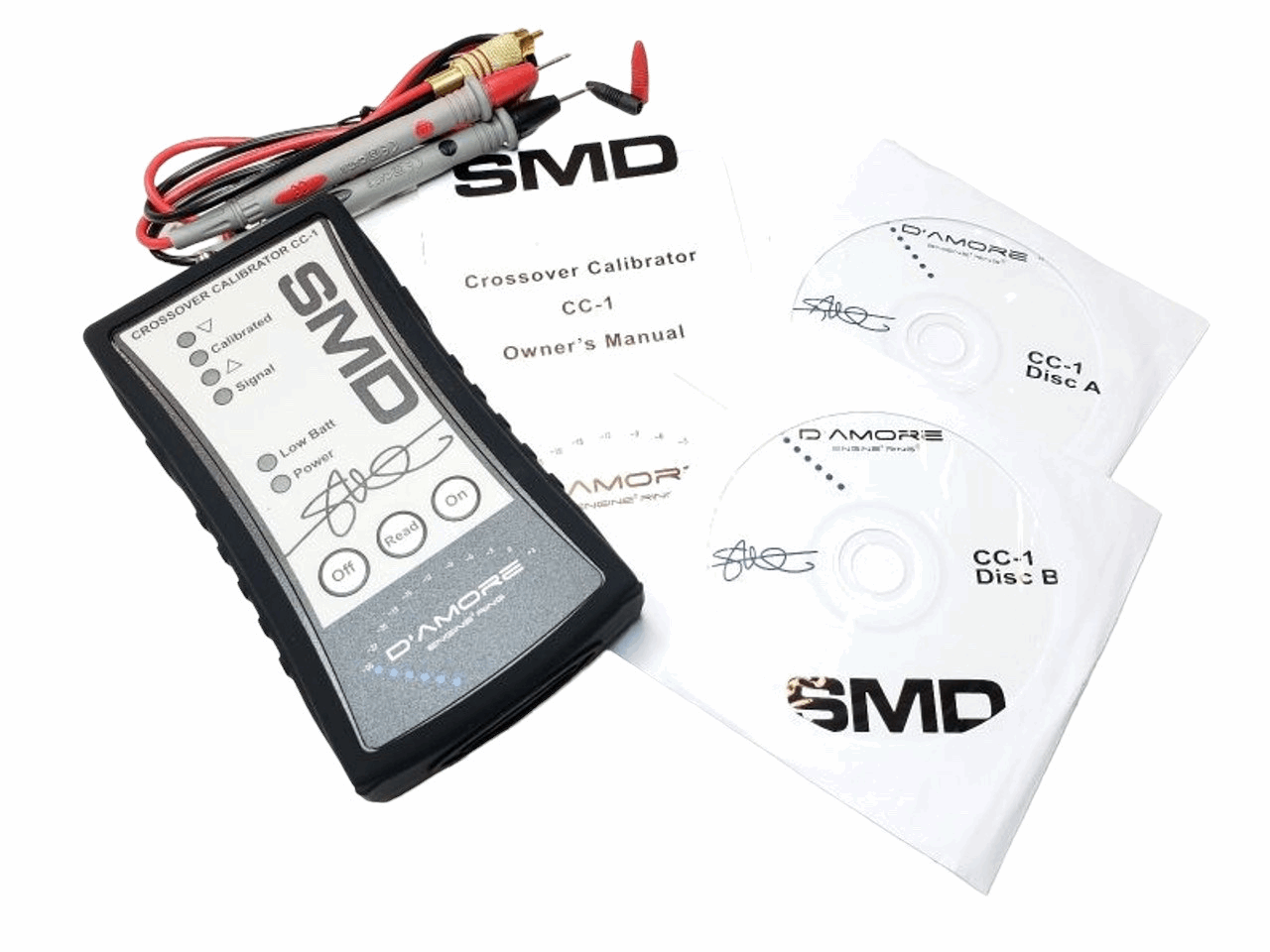 Image of the SMD Crossover Calibrator CC-1 by Steve Meade Designs. Included are the calibrator, ideal for gain matching amplifiers, two CDs labeled Disc A and Disc B, an owner's manual, cables with connectors, and a probe branded by SMD.