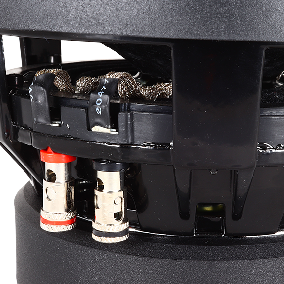 A close-up of a SA-Series v.2 6.5 Subwoofer by Sundown Audio shows two connectors with red and black rings, wrapped wires, and exposed inner materials, highlighting its high-performance design like a subwoofer.
