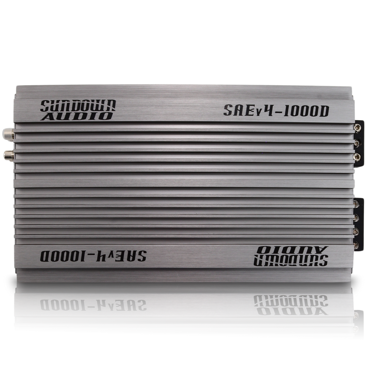 Three Sundown Audio SAEv4-1000.1D amplifiers stacked, featuring a sleek metallic silver finish with black logos. These Class D mono amplifiers boast modern design elements, visible screws, and connection ports on one edge for easy installation.