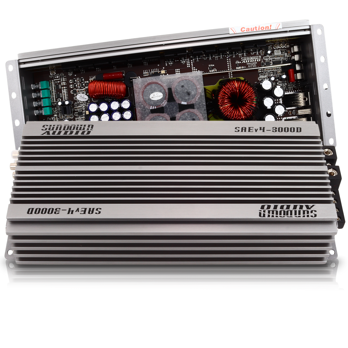The Sundown Audio SAEv4-3000.1D amplifier is a sleek silver Class D car audio amp with visible internal components like coils and capacitors. Its ribbed casing and protective circuitry ensure top performance, while the partially open top reveals the circuit board inside.