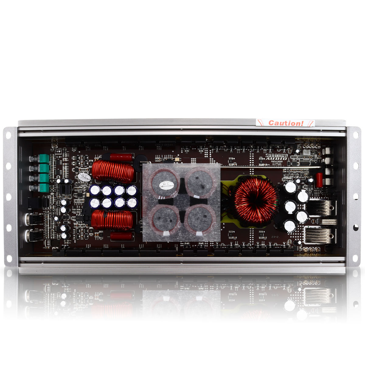A detailed view of the Sundown Audio SAEv4-3000.1D Amplifier circuit board with capacitors, coils, and connectors enclosed in a metal frame labeled Caution! at the top edge, resembling a compact Class D amplifier used in car audio systems.