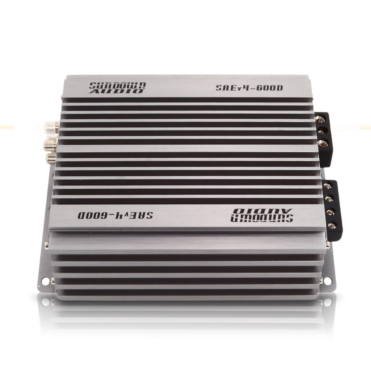 The Sundown Audio SAEv4-600.1D Mono Amplifier features a ribbed silver casing with sleek black accents and engraved branding. This powerful car audio amplifier offers multiple side connection ports for versatile connectivity.