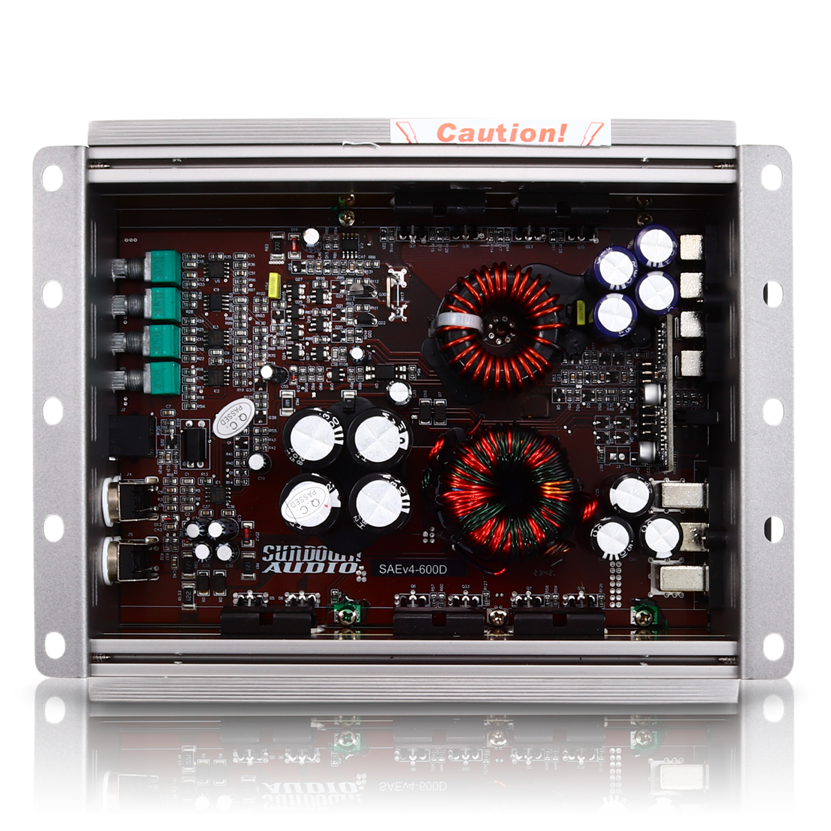 The interior of the Sundown Audio SAEv4-600.1D Mono Amplifier, a Class D car audio amplifier, displays components such as capacitors, coils, and a circuit board. The metallic enclosure with mounting brackets features a Caution! label on its top edge.