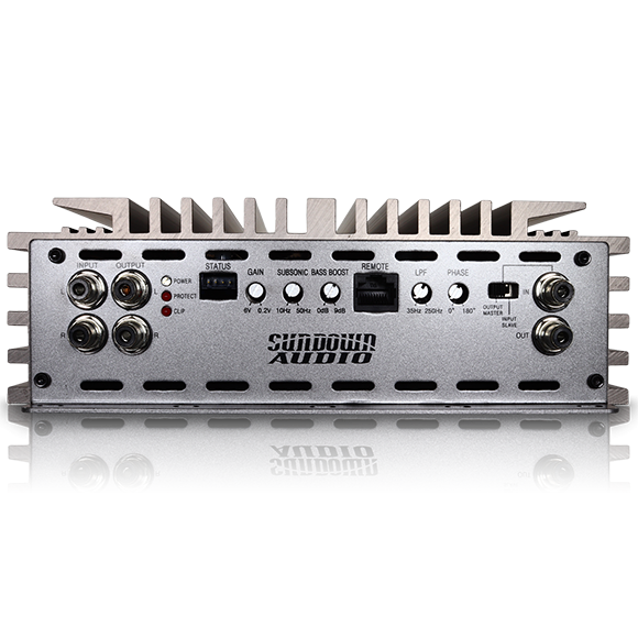 The rear view of a silver Sundown Audio SALT-2 2000W Class D Amplifier showcases various input and output ports, labeled controls, and a cooling fin design, with the brand name Sundown Audio prominently visible on the Korean Class-D amplifier unit.