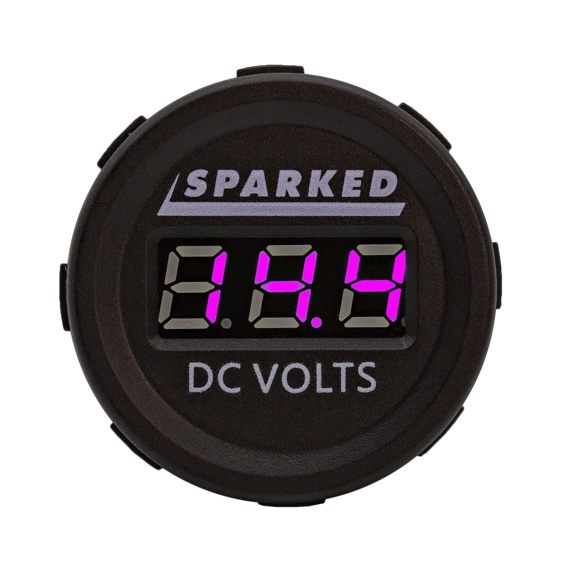 The Single 12VDC Voltmeter Battery Voltage Monitor by Sparked Innovations boasts an IP67 waterproof rating, with a circular black casing and an LED display that clearly indicates 13.8 in pink numbers. The top displays the brand "SPARKED," while the bottom reads "DC VOLTS," ensuring accurate 12VDC measurements.