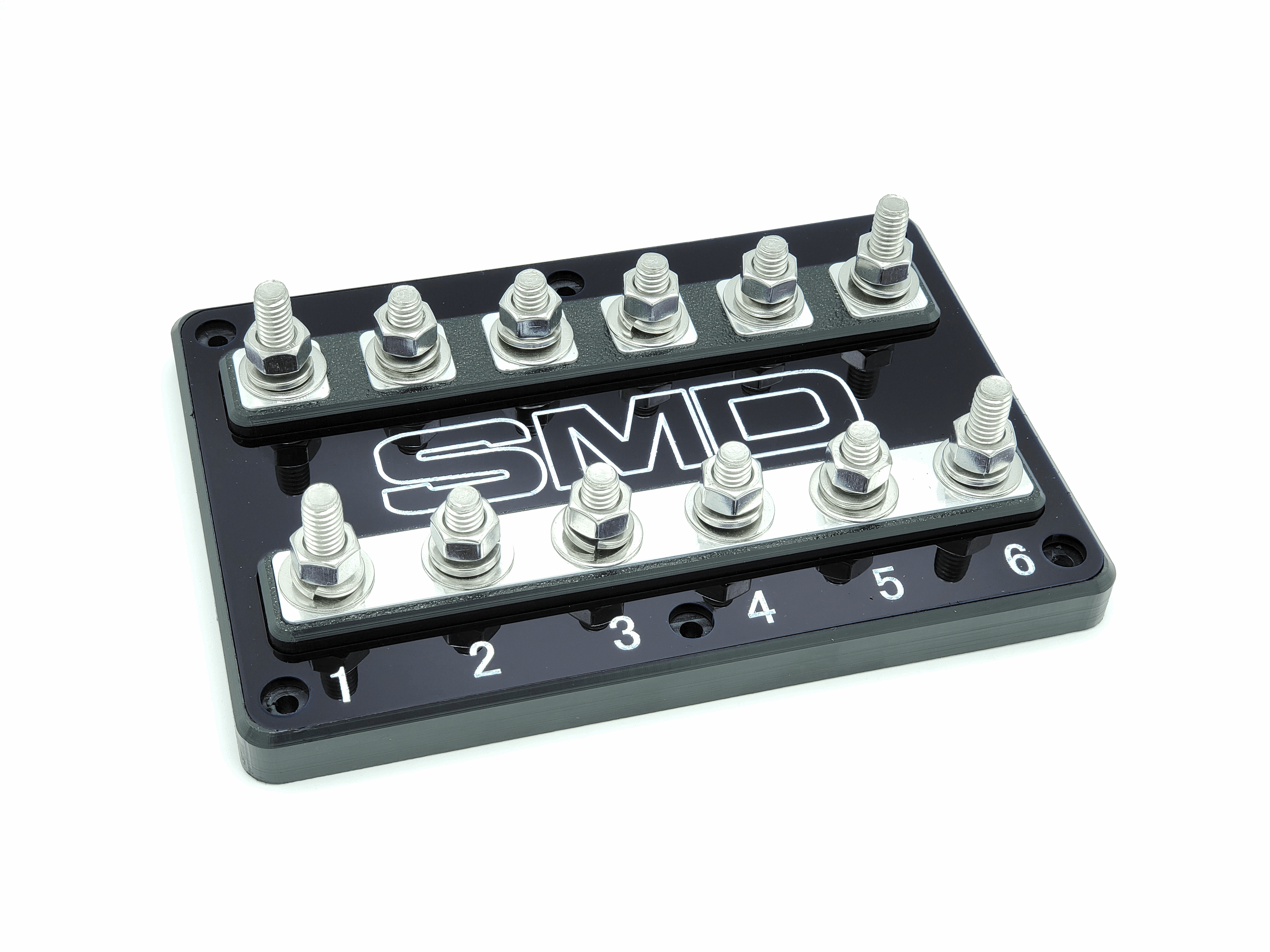 The SMD Hex 6-Spot ANL Fuse Block from Steve Meade Designs includes six numbered terminals marked 1 through 6, with rows of bolts designed for secure electrical connections. The fuse block is black, features a glossy finish made from high-density polyethylene, and prominently displays the SMD logo in the center.