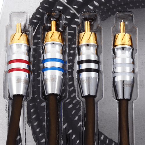 Four Sundown Audio SAZ4-25FT RCA interconnects, made with oxygen-free copper and gold connectors, are neatly arranged in a clear plastic tray. Each cable is adorned with a distinct colored band: red, white, blue, and black.