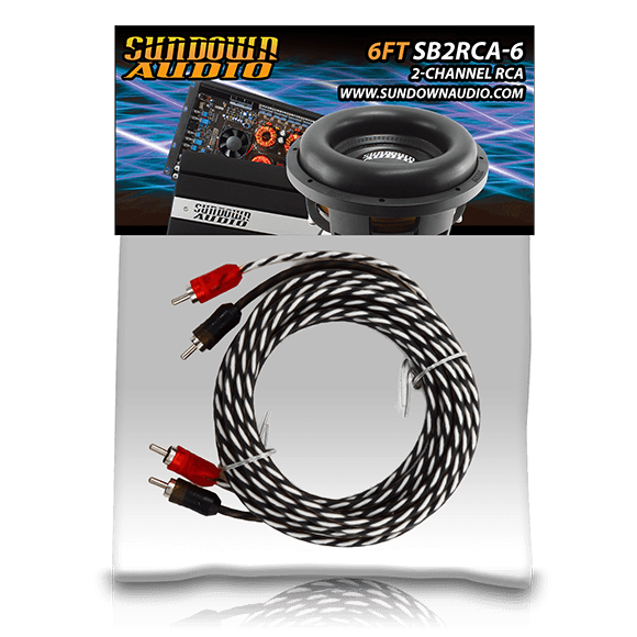 Coiled black and white RCA interconnects with red and black connectors are shown, with a Sundown Audio subwoofer and audio equipment labeled as SB2-6FT 2-Channel RCA in the background.