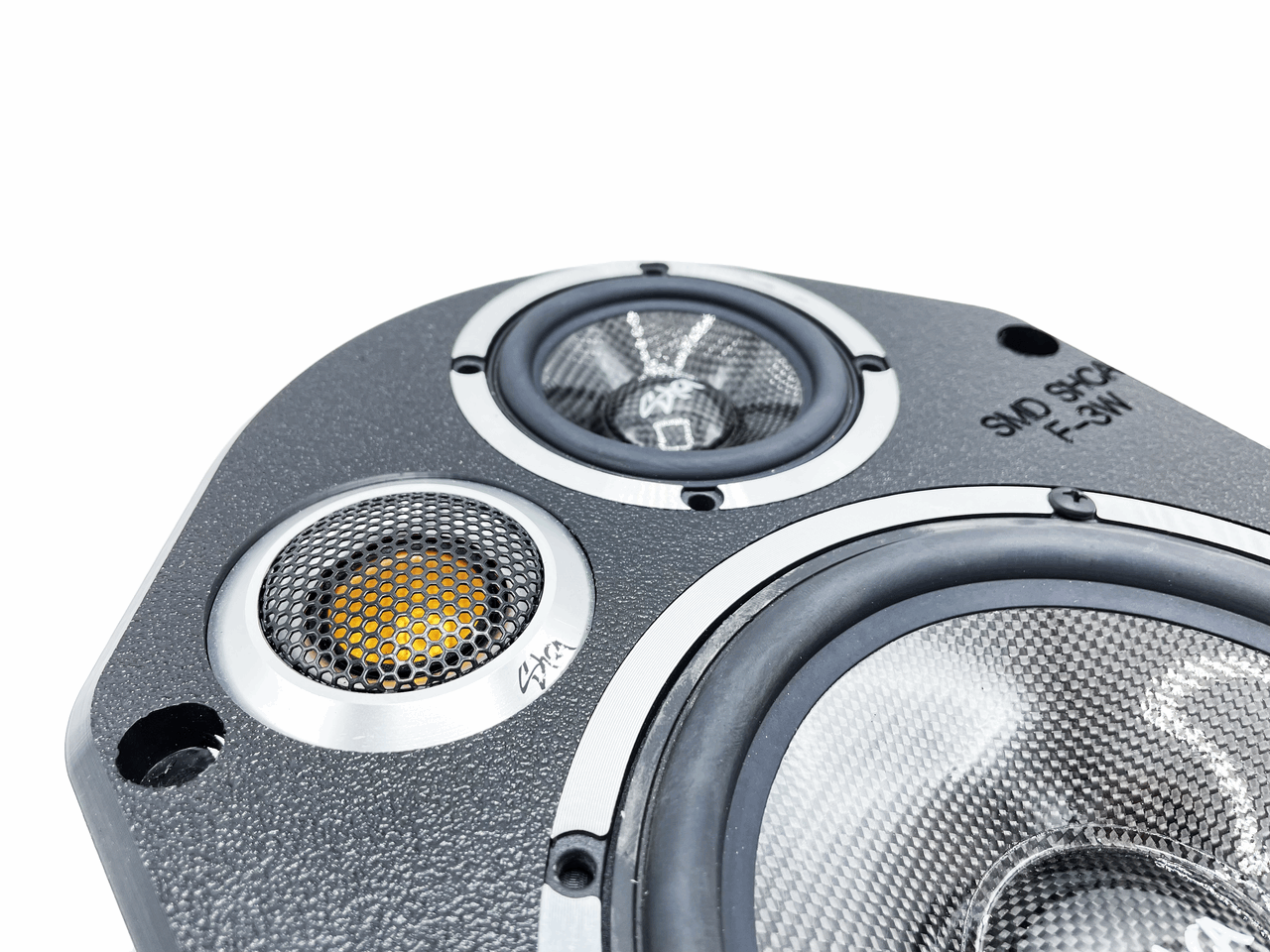 A close-up of an exquisite speaker featuring three drivers: a pair of smaller, round ones for high and mid frequencies, alongside a larger one for low frequencies. Its elegant metallic design with mesh covers seamlessly complements Ford vehicles when paired with SMD Ford 3-Way Speaker Adapters by Sky High Car Audio from Steve Meade Designs.