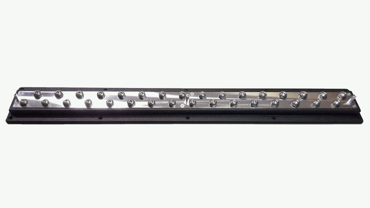 A stylish, rectangular SMD 25" Power - Ground distribution bar by Steve Meade Designs features multiple small, round slots aligned in a row on a metallic strip, encased in a black frame. This piece is ideal for elevating the aesthetic of your car audio system against a crisp white background.