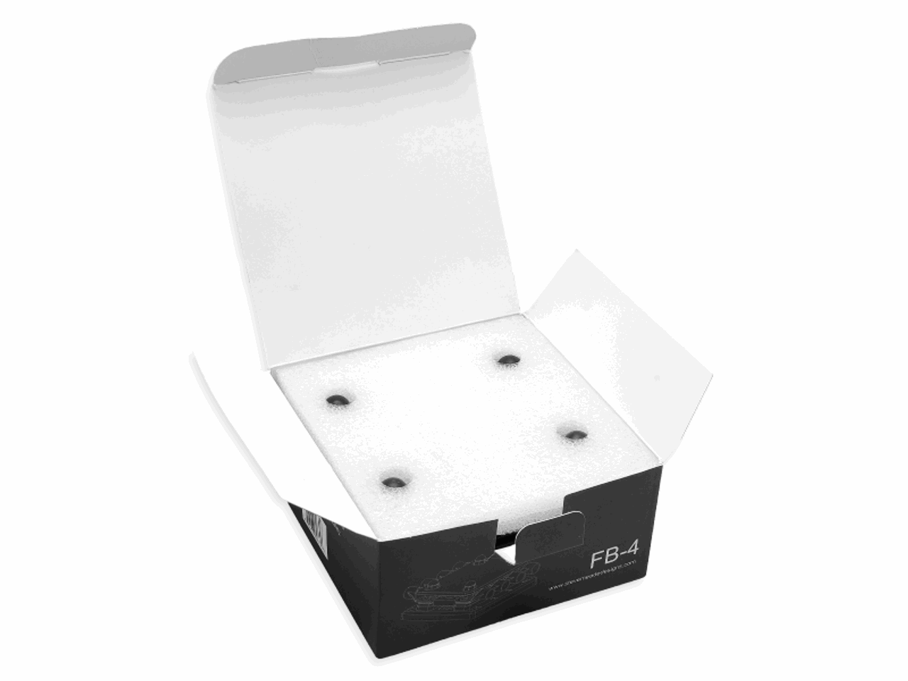 Unsealed black and white cardboard box with a white foam insert, intended for vehicle protection. The box, featuring the label FB-4 in sharp white text, is likely to contain an SMD FB-4 Quad Fuse Block by Steve Meade Designs.