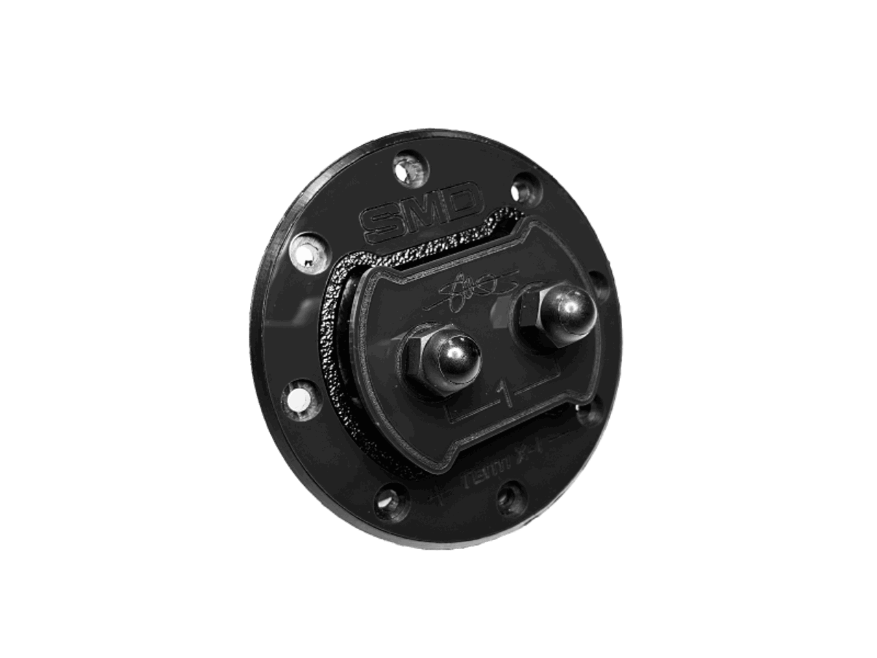 Close-up of the SMD 1 Channel Speaker Terminal X-1 (TX-1) by Steve Meade Designs, a round, black metal component with two bolt heads and engraved markings, symbolizing a reliable connection, set against a white background.