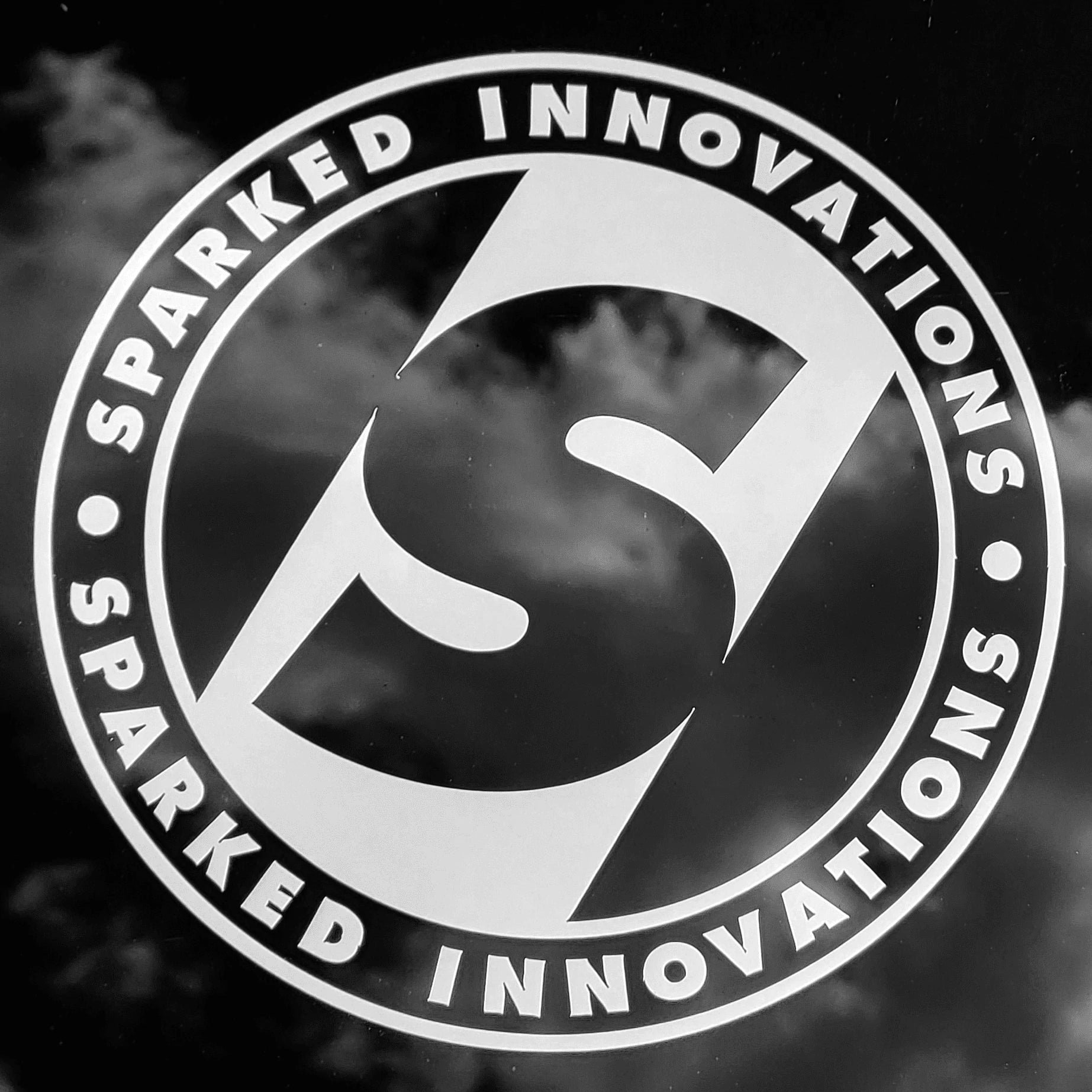 Sparked Innovations white vinyl circle S logo